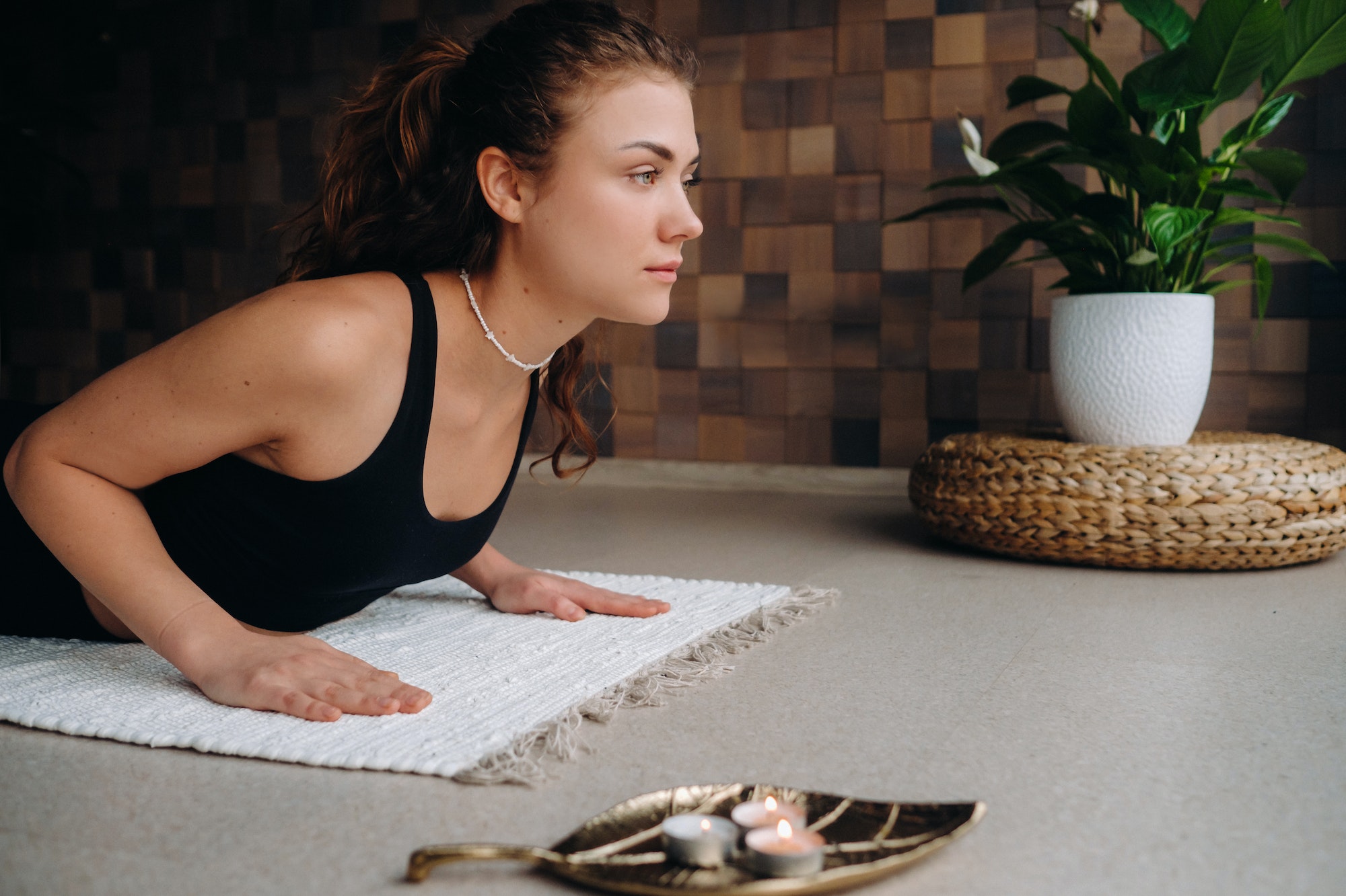 A young woman in black clothes is doing yoga in a modern gym.The concept of health